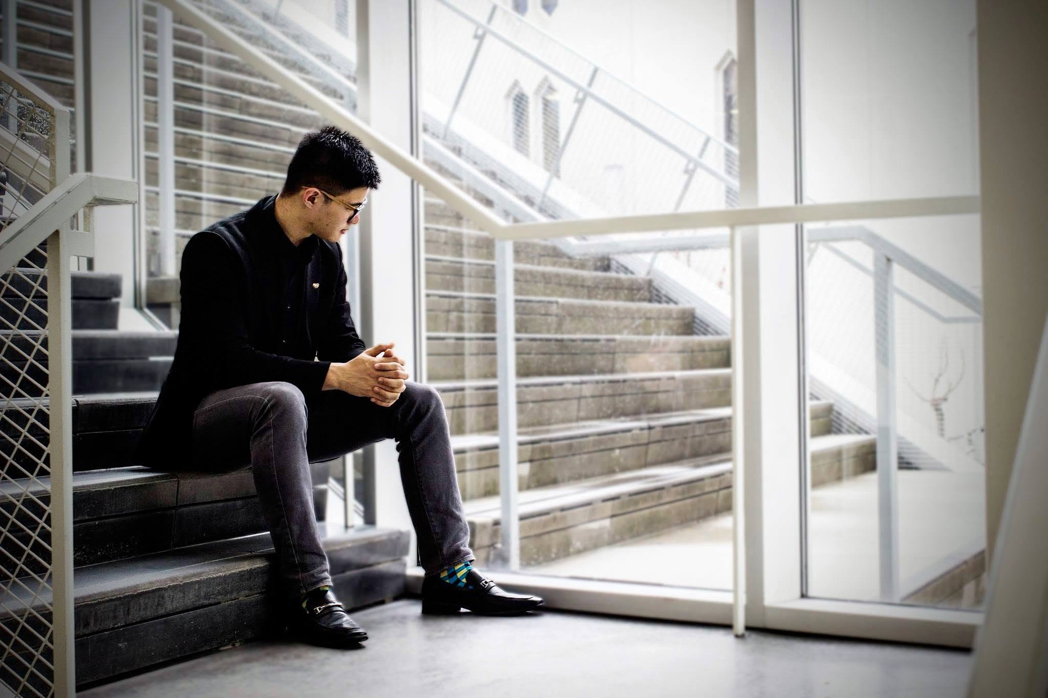 Stephen Joven-Lee seated on a staircase at Oberlin Conservatory